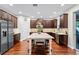 Beautiful kitchen with stainless steel appliances, dark wood cabinets, and a marble island at 10078 Greenshire Way, Orlando, FL 32827