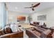 Spacious living room features hardwood floors, stylish furniture, and a modern ceiling fan at 10078 Greenshire Way, Orlando, FL 32827
