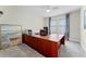 Bright office space with a large desk, neutral decor, and plenty of natural light at 10078 Greenshire Way, Orlando, FL 32827