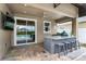 This outdoor kitchen features barstool seating and a clear view of the sparkling pool for outdoor entertaining at 10078 Greenshire Way, Orlando, FL 32827