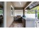Enjoy outdoor dining with a built-in kitchen featuring a grill, counter space, and a cozy patio area at 10078 Greenshire Way, Orlando, FL 32827