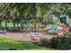 Charming community playground featuring a fun airplane structure and slide, nestled among lush trees at 10078 Greenshire Way, Orlando, FL 32827