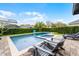 Inviting backyard pool with a spa, surrounded by lush greenery and comfortable patio furniture at 10078 Greenshire Way, Orlando, FL 32827