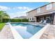 Backyard pool and spa area with a covered outdoor kitchen, perfect for relaxation and entertainment at 10078 Greenshire Way, Orlando, FL 32827