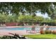 Inviting community pool with lounge chairs, lush greenery, and clear blue water, perfect for relaxation at 10078 Greenshire Way, Orlando, FL 32827