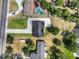 Aerial view of the house with a long driveway, pool and lake views at 1070 Lake Ariana Blvd, Auburndale, FL 33823