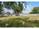 Backyard view shows home with fenced yard and view of the lake at 1070 Lake Ariana Blvd, Auburndale, FL 33823