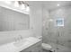 This bathroom features a glass shower and marble countertops at 1070 Lake Ariana Blvd, Auburndale, FL 33823