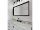 Bathroom features a modern vanity with a marble countertop, a sleek black faucet, and modern lighting at 1070 Lake Ariana Blvd, Auburndale, FL 33823