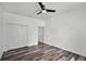 This bedroom features wood-look flooring, a ceiling fan, and a closet at 1070 Lake Ariana Blvd, Auburndale, FL 33823