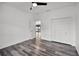 This bedroom features wood-look flooring, a ceiling fan, and a closet at 1070 Lake Ariana Blvd, Auburndale, FL 33823