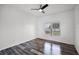 Bright bedroom with a large window, ceiling fan, and modern flooring at 1070 Lake Ariana Blvd, Auburndale, FL 33823