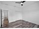 This bedroom features wood-look flooring, a ceiling fan, and a closet at 1070 Lake Ariana Blvd, Auburndale, FL 33823