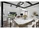 Open dining room with marble table, modern light fixture, and floor-to-ceiling windows at 1070 Lake Ariana Blvd, Auburndale, FL 33823