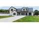 Striking two-story modern farmhouse with black trim and a well manicured lawn at 1070 Lake Ariana Blvd, Auburndale, FL 33823