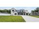 Charming two-story modern farmhouse with black trim and a sprawling green lawn at 1070 Lake Ariana Blvd, Auburndale, FL 33823