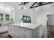 Bright kitchen with a large island, modern appliances, and sliding glass doors to the outside at 1070 Lake Ariana Blvd, Auburndale, FL 33823