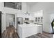 Open kitchen features modern appliances, white cabinets, large island, and high ceilings at 1070 Lake Ariana Blvd, Auburndale, FL 33823