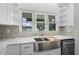 Modern kitchen sink with stainless steel fixtures and a view of the water outside the window at 1070 Lake Ariana Blvd, Auburndale, FL 33823