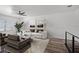 Cozy living room featuring a plush sofa, ceiling fan, and a serene view from the window at 1070 Lake Ariana Blvd, Auburndale, FL 33823