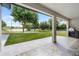 This patio features stone-look tile with a view of the lake and outdoor kitchen at 1070 Lake Ariana Blvd, Auburndale, FL 33823