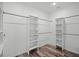 Spacious walk-in closet with built-in shelving and hanging rods provides ample storage space and organization at 1070 Lake Ariana Blvd, Auburndale, FL 33823
