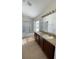 Well-lit bathroom with double sinks, a shower-tub combination, and modern fixtures at 10711 Yellow Tiger Lily Dr # S, Orlando, FL 32832
