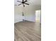 Spacious main bedroom featuring modern flooring, a ceiling fan, and an archway leading to the bathroom at 10711 Yellow Tiger Lily Dr # S, Orlando, FL 32832