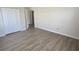 Spacious bedroom with wood-look flooring and a large closet with folding doors at 10711 Yellow Tiger Lily Dr # S, Orlando, FL 32832