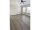 Bright bedroom with modern flooring, a ceiling fan, and multiple windows providing natural light at 10711 Yellow Tiger Lily Dr # S, Orlando, FL 32832