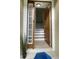 Inviting entryway with a side window, a wood-look door and tile flooring that leads to the stairs at 10711 Yellow Tiger Lily Dr # S, Orlando, FL 32832
