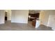 Open-concept living space with hardwood floors, a view of the kitchen, and access to other rooms at 10711 Yellow Tiger Lily Dr # S, Orlando, FL 32832