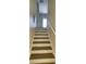 Stairway with light wood stairs and white risers, leading to the upper level of the home at 10711 Yellow Tiger Lily Dr # S, Orlando, FL 32832