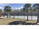 Community tennis courts surrounded by palm trees and a black fence at 10711 Yellow Tiger Lily Dr # S, Orlando, FL 32832
