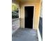 View of the black door from the balcony overlooking a peaceful parking lot at 1081 S Hiawassee Rd # 723, Orlando, FL 32835