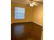 Bedroom featuring updated hardwood flooring, a ceiling fan, and a bright window at 1081 S Hiawassee Rd # 723, Orlando, FL 32835