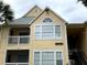 Two-story condo features light yellow siding, white trim, and a balcony on the second floor at 1081 S Hiawassee Rd # 723, Orlando, FL 32835
