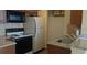 Galley kitchen features granite countertops, stainless steel sink, and black appliances at 1081 S Hiawassee Rd # 723, Orlando, FL 32835