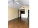 Bright living room with vaulted ceiling and updated hardwood floors leading to the kitchen at 1081 S Hiawassee Rd # 723, Orlando, FL 32835