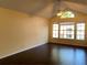 Living room featuring hardwood floors, high ceiling with ceiling fan and large bright window at 1081 S Hiawassee Rd # 723, Orlando, FL 32835