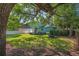 Picturesque backyard with mature trees, green lawn and covered porch visible at 1111 Guernsey St, Orlando, FL 32804