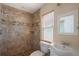 Bathroom featuring tiled walls, a shower, toilet and a sink with a mirror at 1111 Guernsey St, Orlando, FL 32804