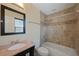 Clean, updated bathroom featuring tub, shower, and a granite-topped vanity at 1111 Guernsey St, Orlando, FL 32804