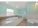 Bathroom with large tub, tile surround, and light blue walls and trim at 1111 Guernsey St, Orlando, FL 32804