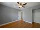 Bedroom features wood floors, gray walls, ceiling fan and walk in closet at 1111 Guernsey St, Orlando, FL 32804