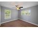 Cozy bedroom featuring carpet floors, two windows, and a ceiling fan at 1111 Guernsey St, Orlando, FL 32804