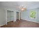 Light and airy bedroom with a ceiling fan, carpet floors, and ample closet space at 1111 Guernsey St, Orlando, FL 32804