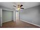Neutral bedroom featuring carpet floors, closet, and a ceiling fan at 1111 Guernsey St, Orlando, FL 32804