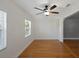 A well lit dining room with hardwood floors, white walls, and ceiling fan at 1111 Guernsey St, Orlando, FL 32804