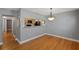 Open-concept dining area with hardwood floors and a passthrough to the kitchen, offering an inviting, airy space at 1111 Guernsey St, Orlando, FL 32804